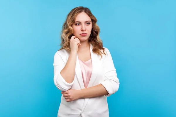 Portrait of thoughtful business woman with wavy hair in white ja — Stock Photo, Image