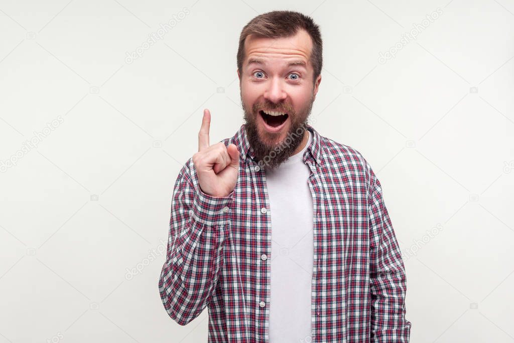 Eureka! Portrait of excited joyful bearded man pointing finger u