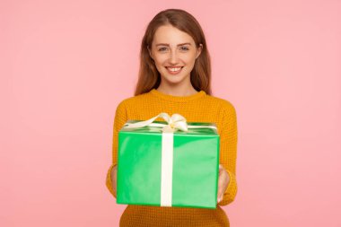 Portrait of cheerful pretty ginger girl holding big gift box and clipart
