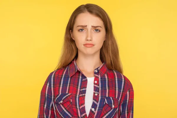 Portrait of unhappy ginger girl in checkered shirt frowning and — Stock Photo, Image