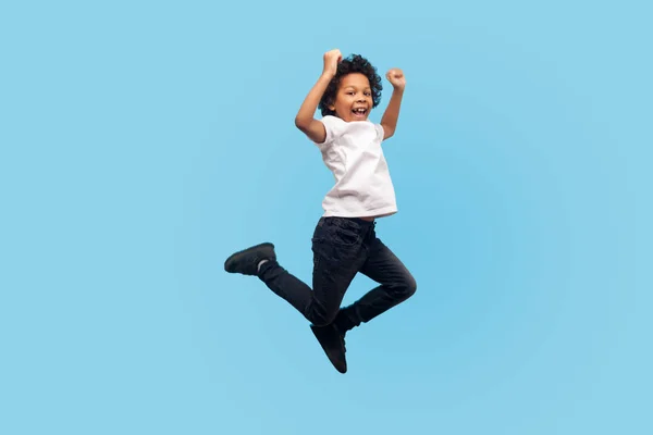 Full length, lively energetic little boy in T-shirt and denim ju — Stock Photo, Image