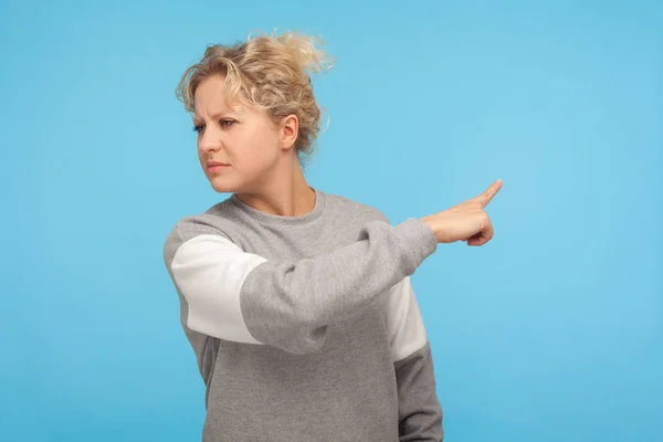 Leave me! Resentful woman with curly hair in sweatshirt pointing — 스톡 사진