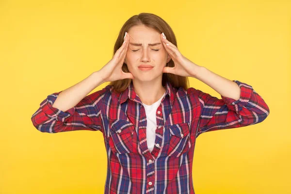 Headache. Portrait of stressed girl in checkered shirt clasping — Stock Photo, Image