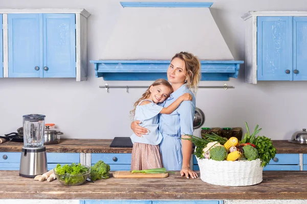 Beautiful mother hugging lovely daughter and looking at camera, — Stock Photo, Image