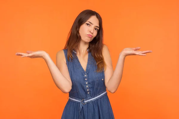 Jag vet inte! Förvirrad brunett kvinna i denim klänning visar ind — Stockfoto