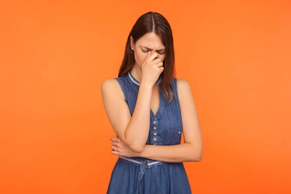 Frustrated sad brunette woman in denim dress crying, wiping away — Stock Photo, Image