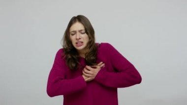 Cardiac problems. Overworked stressed woman panicking from pain in chest, scared of heart attack