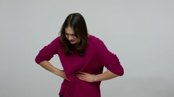 Painful periods. Unhealthy woman in pullover grimacing and clutching belly, suffering severe stomach ache — Stock Video