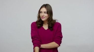 Please, be quiet! Nice-looking brunette woman in pullover putting finger on lips, making silence gesture