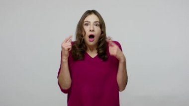 Wow, unbelievable! Surprised brunette woman in pullover looking startled and pointing to camera