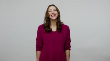 Happy overjoyed nice-looking brunette woman in pullover holding stomach and laughing out loud