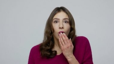 Wow, unbelievable! Astonished amazed brunette woman in pullover covering mouth with hand