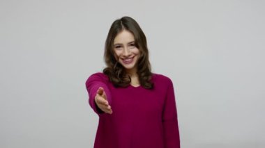 Welcome, happy to meet! Sociable friendly brunette woman in pullover offering hand to handshake