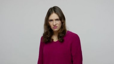No, don't want to watch! Brunette woman in pullover grimacing in disgust and covering eyes with hand