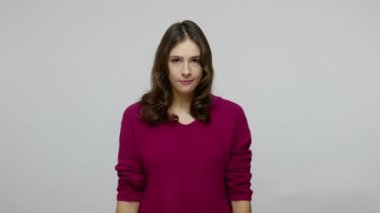 Upset brunette woman with displeased impatient expression pointing to wrist, warning about late hour