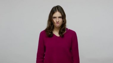 Irritated brunette woman in pullover closing ears with fingers and saying no, ignoring conflict