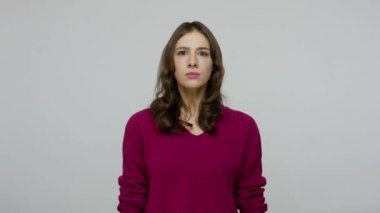 Responsible nice-looking brunette woman in pullover nodding Yes sir and saluting to camera