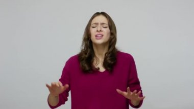 Blind woman in pullover walking in darkness with desperate disoriented expression, touching air searching obstacles