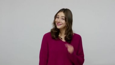 Fascinating brunette woman smiling happily and pointing to copy space