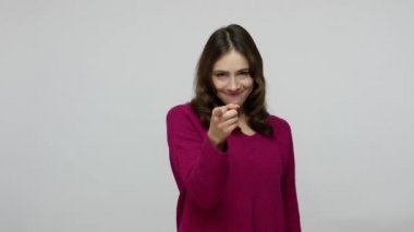 Hey you, come here! Beautiful brunette woman in pullover inviting to approach, making beckoning gesture