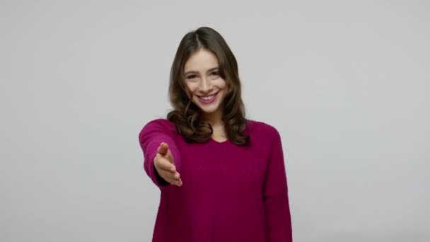 Welcome, happy to meet! Sociable friendly brunette woman in pullover offering hand to handshake — 图库视频影像