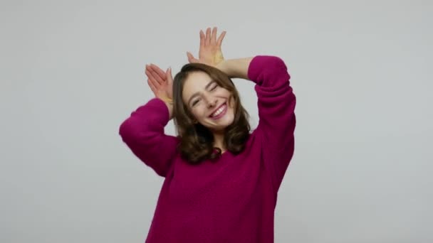 I'm rabbit! Amusing childish nice-looking woman in pullover showing bunny gesture and making faces — Stockvideo