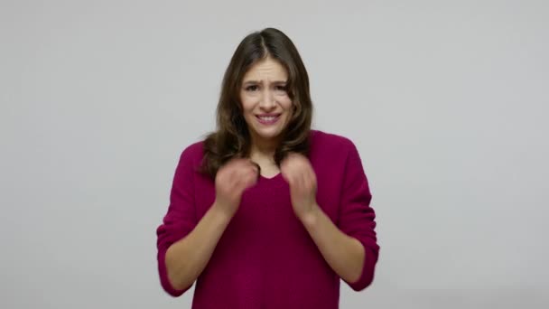 Feelings of anxiety, fear. Confused frightened brunette woman in pullover biting nails, looking scared — Stockvideo