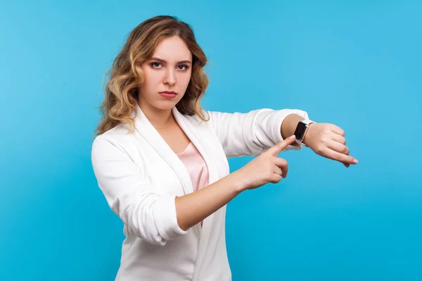 Times up! Portrait of serious woman pointing at watch on hand an — Stock Photo, Image