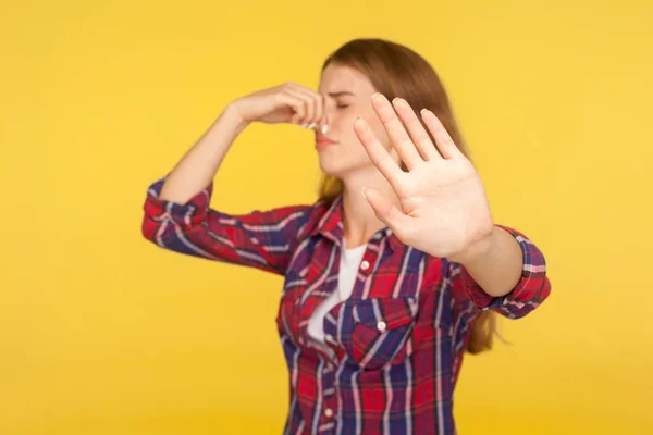 Bad smell. Portrait of displeased ginger girl in checkered shirt — Stock Photo, Image