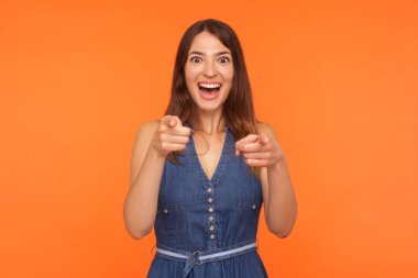 Wow, hey you! Amazed smiling beautiful brunette woman in denim d