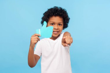 Portrait of wonderful happy preschool boy holding blue Like icon