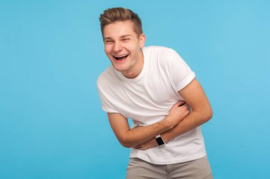 Hilarious joke! Portrait of laughing man holding his stomach and