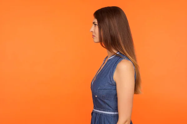 Profile of beautiful woman with long brunette hair and in denim — Stockfoto