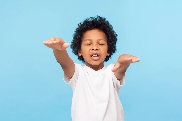 Portrait of blind little curly boy walking with closed eyes and — Stock Photo, Image