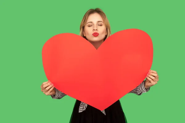 Portrait of lovely charming woman holding large red heart and se — Stok fotoğraf