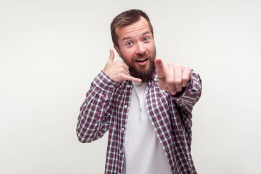 Hey you, call me back! Portrait of positive bearded man pointing