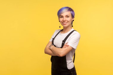Portrait of positive cute hipster woman smiling at camera and cr