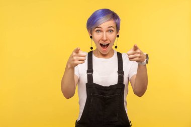 Hey you! Portrait of surprised positive hipster woman pointing f