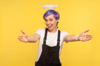 Portrait of friendly cute hipster girl with angelic halo above v