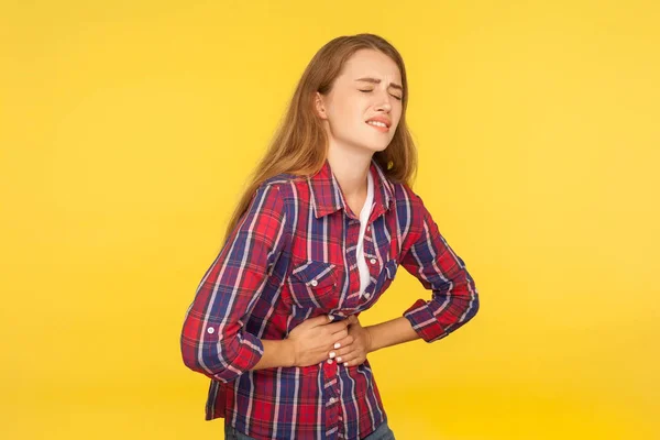 Abdominal pain. Portrait of unhealthy ginger girl in shirt clasp — Stockfoto