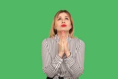 Beseeching woman with beautiful red lips and in blouse holding h