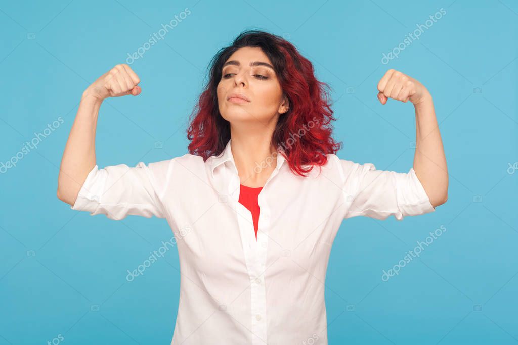 I have power! Portrait of proud woman with fancy red hair raisin