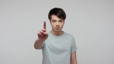 I told you! Serious dissatisfied man making admonishing gesture, disapproval sign, saying no and warning about threaten, giving advice to stay back. indoor studio shot isolated on gray background
