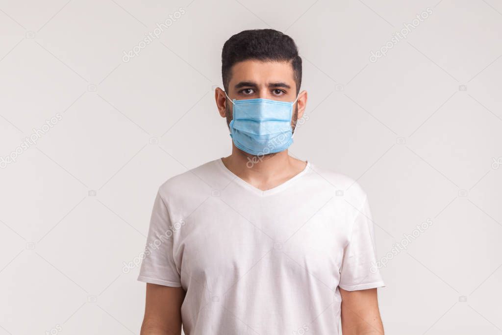 Protection against contagious disease, coronavirus. Man wearing hygienic mask to prevent infection, airborne respiratory illness such as flu, 2019-nCoV. indoor studio shot isolated on white background