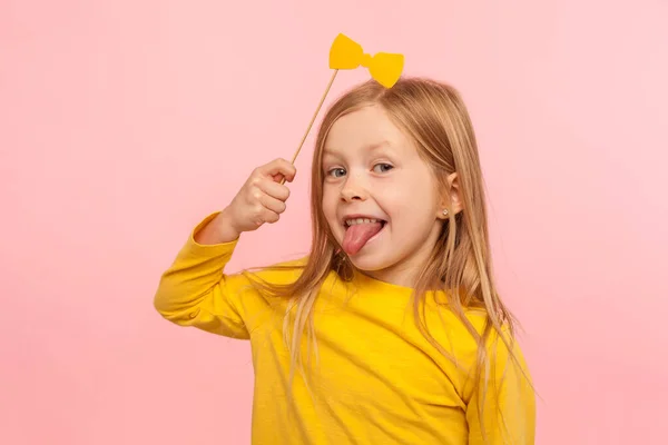 Portrait Playful Adorable Little Ginger Girl Holding Paper Bow Sticking — Stock Photo, Image
