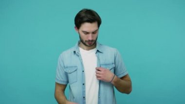 Yakışıklı, sakallı, kotundan kalp jesti çıkaran ve seni sevdiğimi söyleyen, şehvetli duygular ve romantik duygular gösteren bir adam. Mavi arka planda kapalı stüdyo çekimleri