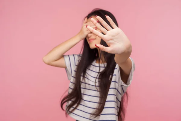 No! Don\'t want to watch! Portrait of displeased girl hiding eyes showing stop gesture, feeling disgusted by seen, refusing to look at shameful bad events, ignoring problem. indoor studio shot isolated