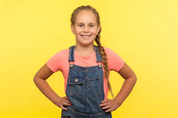 Portrait Cute Little Girl Braid Denim Overalls Holding Hands Hips — Stock Photo, Image