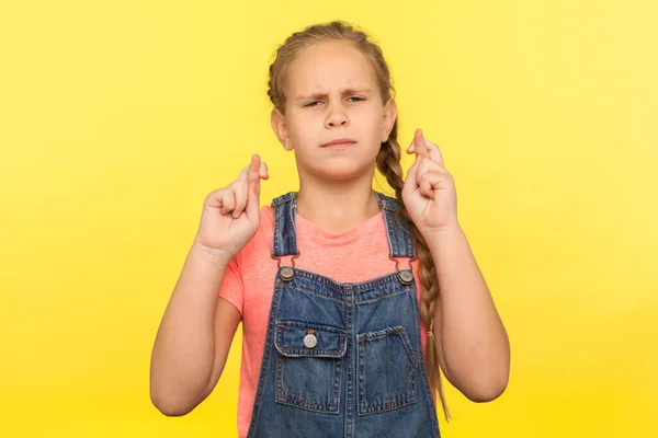 Portrait Hopeful Cute Little Girl Braid Denim Overalls Crossing Fingers — Stock Photo, Image