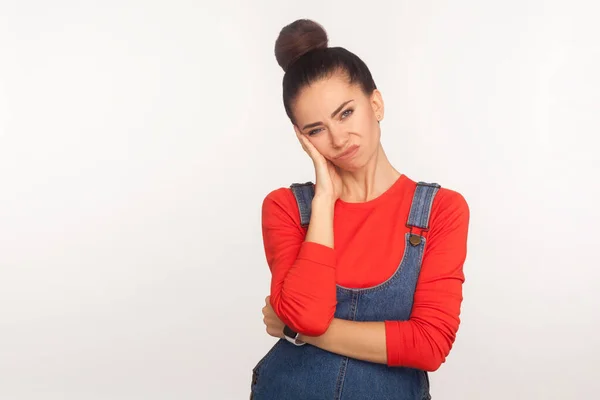 Portrait Frustrated Indifferent Girl Hair Bun Denim Overalls Leaning Hand — Stock Photo, Image